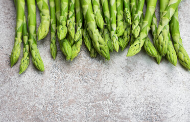 Fresh green asparagus on  concrete background.