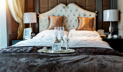 Luxury bedroom interior with beverage on the bed