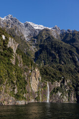 A long waterfall from snow in Milford sound New Zealnad