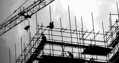 Group of construction workers working on scaffolding