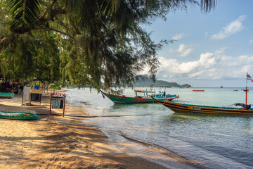 Local taxi boats for tourists in the sea water on shore of Sairee Beach on Koh Tao island in Thailand in the morning. Tropical exotic paradise sandy beach