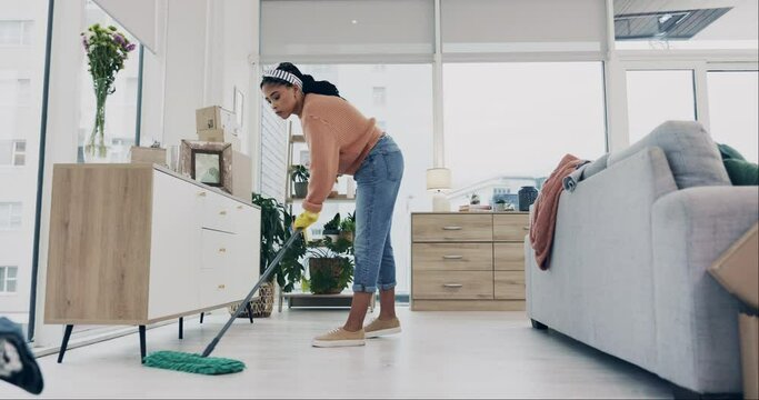 Woman, mopping or cleaning house floor for hygiene, dirt or bacteria safety in housekeeping routine. Person, wipe or equipment for ground dust control, disinfection or germs protection in living room
