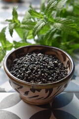 Chinese tea (gun powder) in an exotic bowl with fresh mint behind