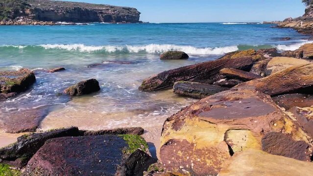 HD Video -The nature reserve at Wattamolla Beach in Royal National Park, South of Sydney, NSW, Australia. Close-up view of the waves splashing on the stones on the side of the bay.