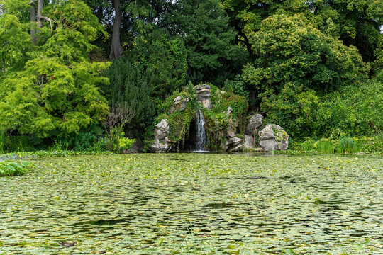 Water Lily (Nympheas) Pond and Cascade in the Bagatelle Park. The Park is located in Boulogne-Billancourt near Paris, France