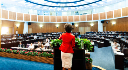 Business woman making a speech at conference hall