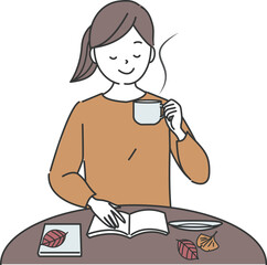 コーヒーを飲みながら読書をする若い女性