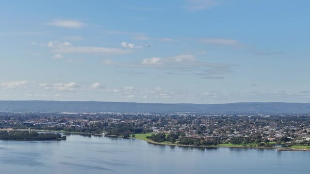 Aerial view of the Perth hills with plane landing into the airport over Swan River