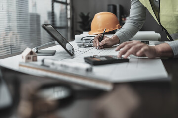 Engineering working with drawings inspection and writing on Blueprint. Engineer, Architect,...