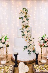 flowers on a table with a wedding cake