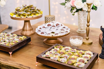 trays of chocolate brigadeiros on a table decorated with flowers for a wedding