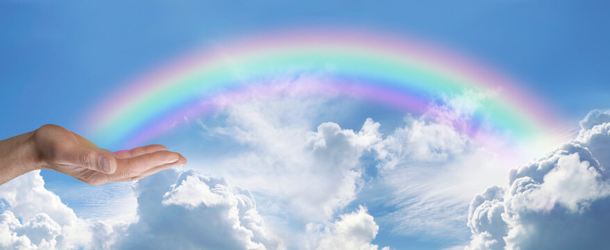 Sending You Beautiful Rainbow Healing Vibes Through The Ether - Blue Sky And Fluffy Clouds With A Male Hands Sending Arcing Rainbow Healing Energy Across The Sky 
