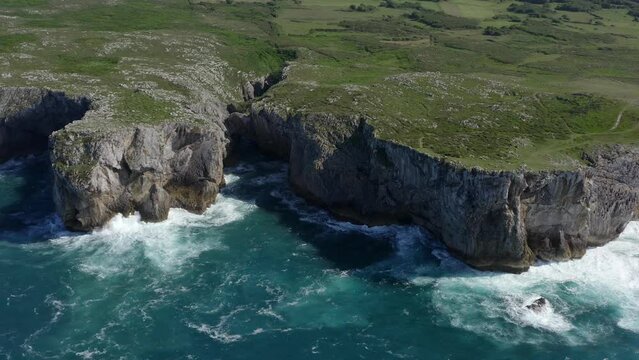 Bufones de pria asturias spain sea cliffs on sunny day, slow motion bird's eye view pullback