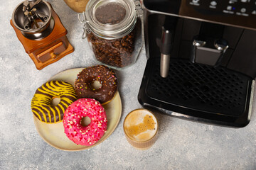Modern coffee machine with a cup and donut on the kitchen table. Coffee house. Modern espresso...