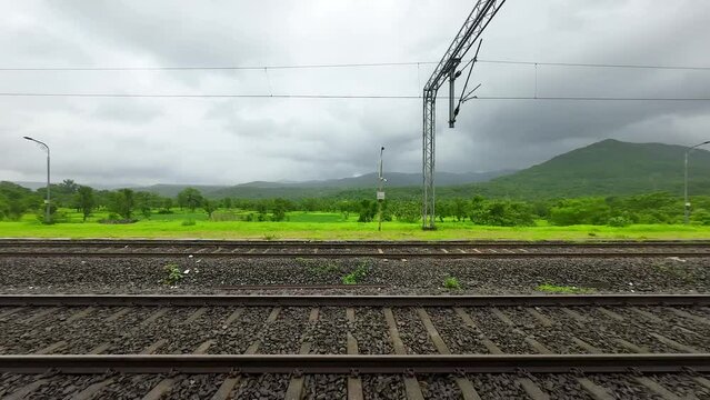 greenery forest hyper laps in rain view from train window in Konkan railway