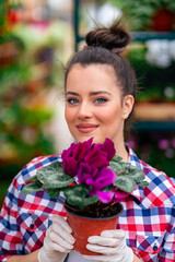 a beautiful blue-eyed flower girl holds purple flowers to the camera