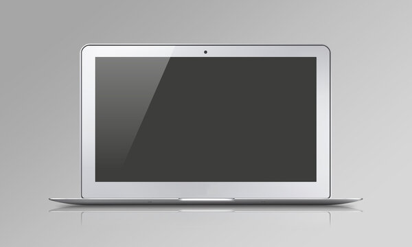 Grey laptop with a blank black screen on grey