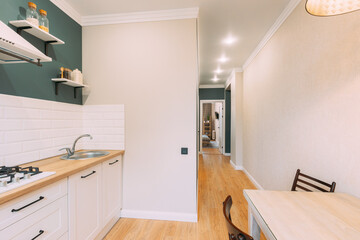 Modern Bright Kitchen In Scandinavian Stylish. Stylish Apartment Interior Of Kitchen, Kitchen Equipment. Family Apartment With Dinner Table And Chairs. Idea For Home Design. Light Colors Of Design.