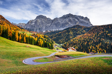 Winding road at the autumn Dolomite Alps. Amazing landscape with mountains on background at San Genesio village location, Province of Bolzano, South Tyrol, Italy - 637793350