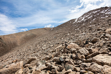 Climbing the peak Tourist through the stones