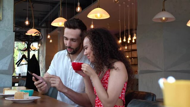 Happy couple spending time together in cafeteria