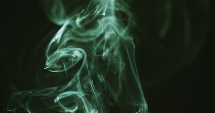 Video of green clouds of smoke moving with copy space on black background
