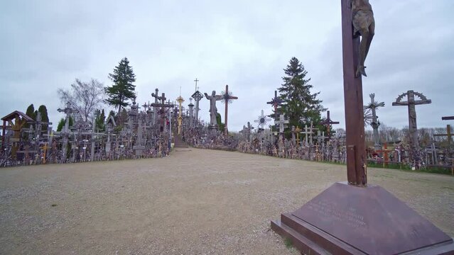 A magnificent religious site, abundant with numerous Christian crosses. A handful of individuals can be spotted ascending the staircase, situated amidst this spiritual panorama.