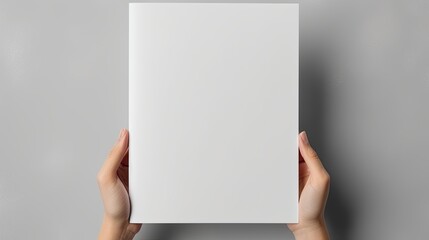 Female hands holding blank magazine gray background design template. Mockup image