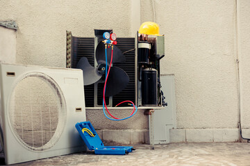 Damaged external air cooling unit with protection cover removed in need of fixing, with...