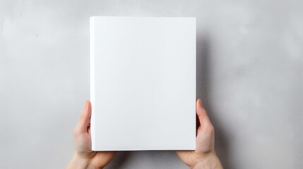 High quality photo of a blank white book mockup in hand on a gray banner background