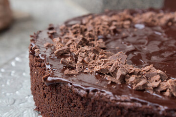 Close up of a delicious looking dark chocolate cake with icing