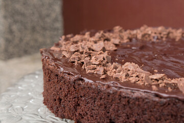 Close up of a delicious looking dark chocolate cake with icing