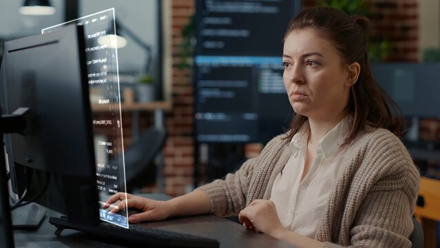 Qualified programmer helped by AR technology to visualize script, writing code on computer screen while in workplace using Java programming languages. Certified engineer solving errors