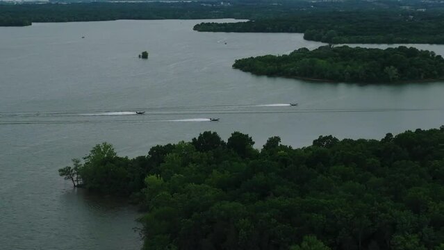 Motorboats Speeding Across Percy Priest Lake In Nashville, Tennessee, USA. aerial pan right