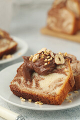 A piece of marble biscuit with chocolate cream and nuts