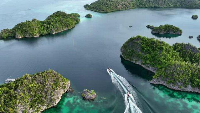 Aerial Forward Shot Of Boats On Sea Amidst Green Islands - Raja Ampat, Indonesia
