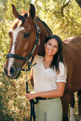 Content horsewoman with horse in summer woods