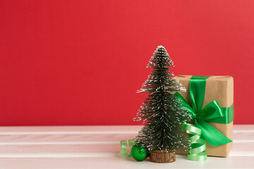 Miniature christmas tree with gift boxes and decor on table