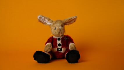 Plush bunny on a yellow background.