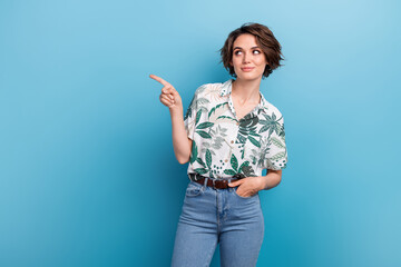 Photo portrait of lovely young lady look point promo empty space dressed stylish print leaves garment isolated on blue color background - obrazy, fototapety, plakaty
