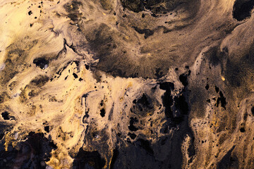 Exclusive beautiful pattern, abstract fluid art background. Flow of blending golden black paints...