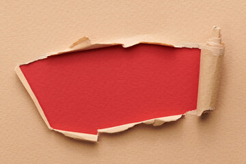Frame of ripped paper with torn edges. Window for text with copy space red beige colors, shreds of notebook pages. Abstract background.