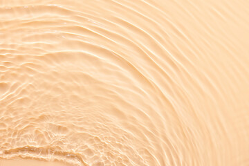 Water beige surface abstract background. Waves and ripples texture of cosmetic aqua moisturizer with bubbles. - obrazy, fototapety, plakaty