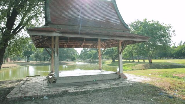 Sala Thai Pavilion in a Green Historical Park in Ayutthaya with a Lake. Dolly Shot.