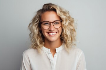 happy smiling blonde haired female wearing glasses on plain background for presentation