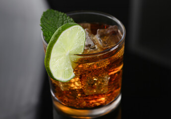 cocktail with cola and mint on a black background