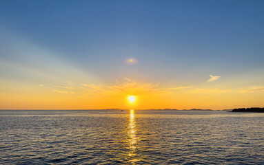 Fototapeta na wymiar Sunset of the bright sun on the sea. You can see beautiful rays.