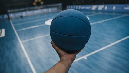 Goalball on court in hand