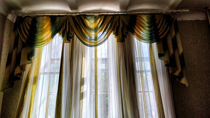 Beautiful curtain on the window and transparent tulle curtain. Abstract background, texture, pattern. Space for text and copy space
