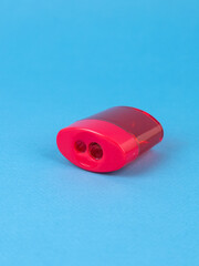 Red Pencil Sharpener Isolated on  blue Background.